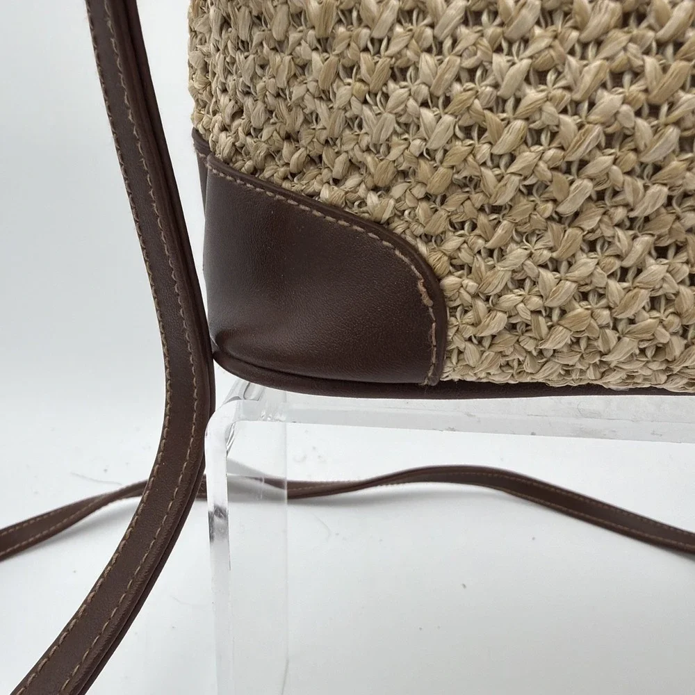 Rosetti straw tote handbag with brown faux leather trim‎ and top handles.